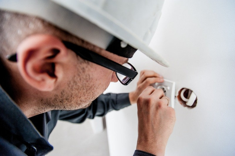 A smart thermostat getting installed