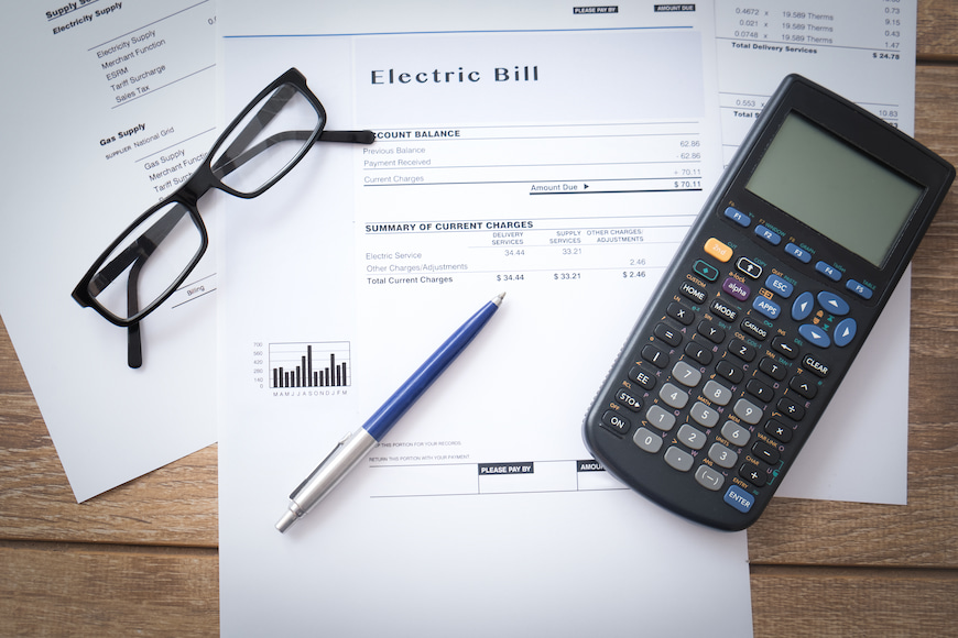 energy bill with calculator and glasses