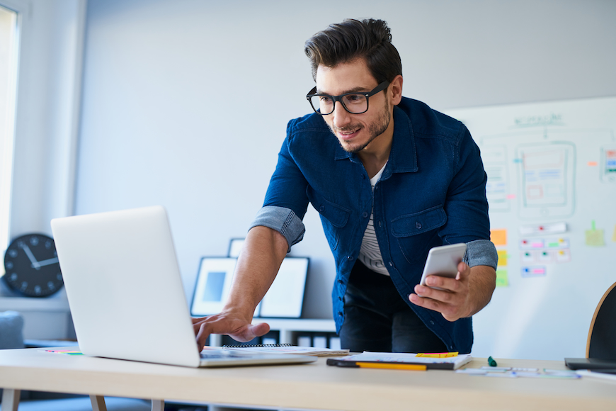 Man looking at laptop to compare internet providers