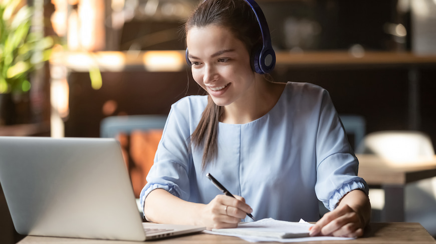 University student attending class online from her laptop at home