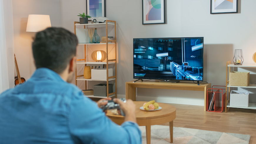 University student playing games on a video game console