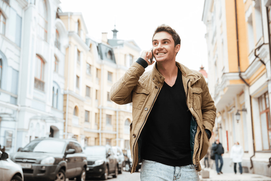 Man walking down the street while talking on the mobile phone.