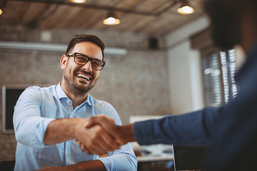 shaking hands and smiling