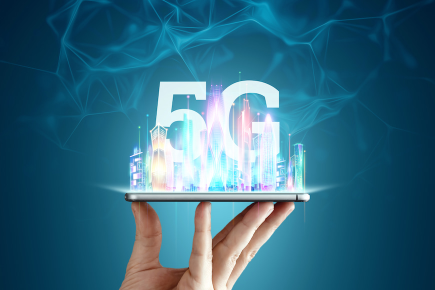 Man holding up a phone that is displaying a 5G holigram