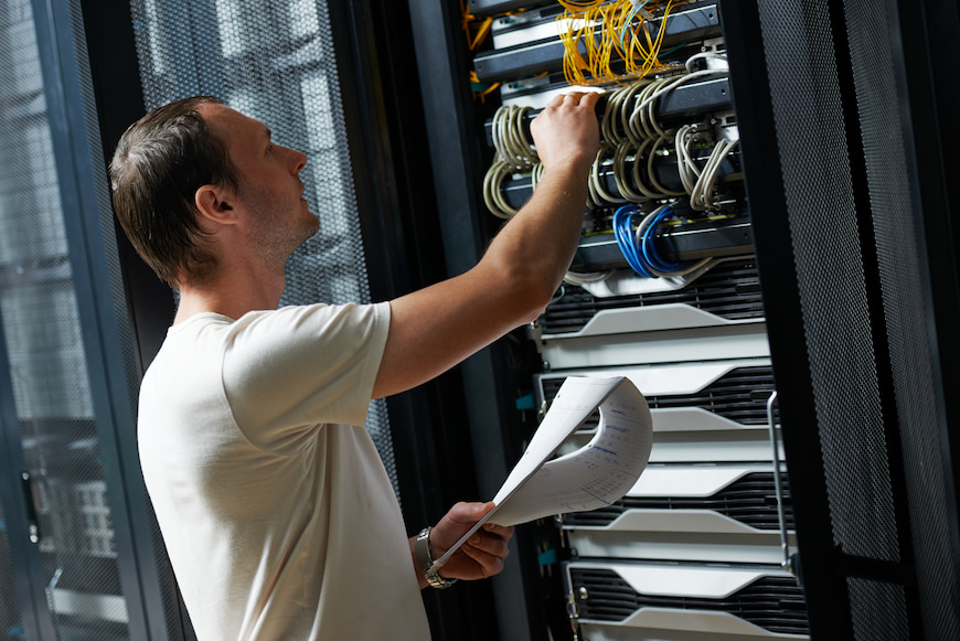 Man working on a server room at an internet provider facility