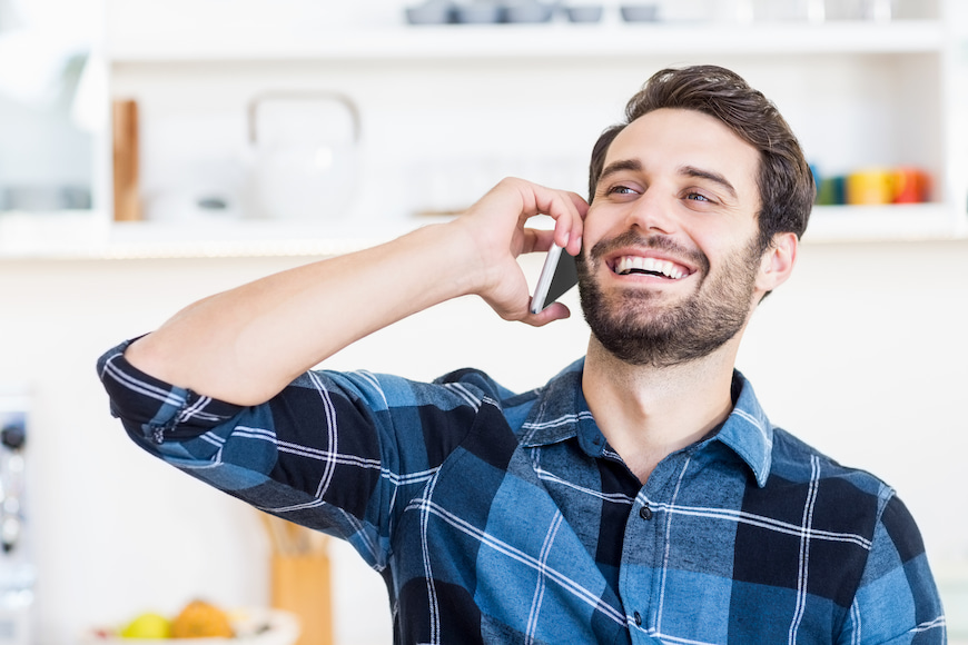 Man talking on the phone in his own home.