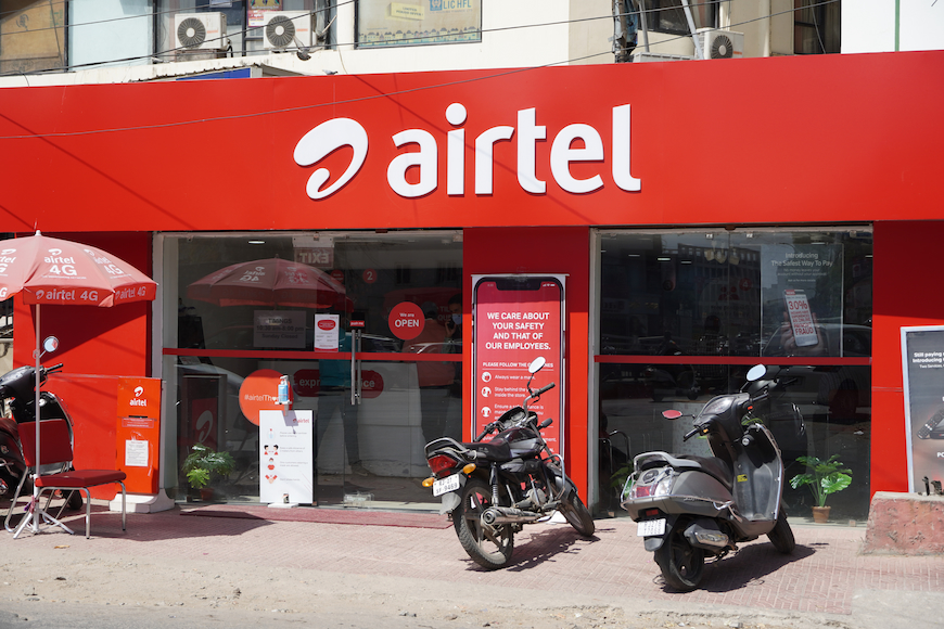 2 bikes parked in front of an Airtel customer center